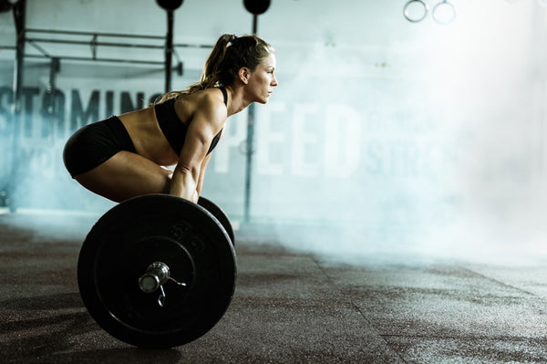 Woman lifts weights in the gym